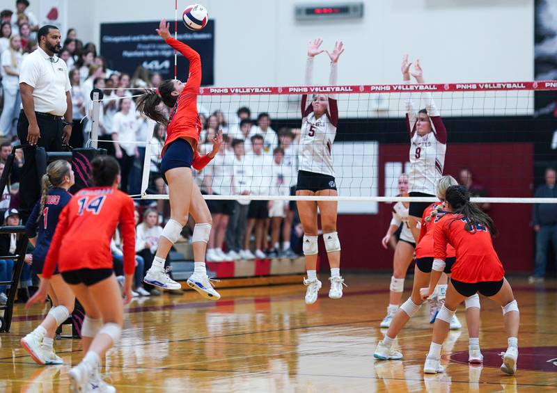 Oswego’s Sidney Hamaker (13) goes up for a kill against Plainfield North's Elizabeth Fitzgerald (5) and Sydney Pavlik (8) during the class 4A Plainfield North regional volleyball final at Plainfield North High School on Thursday, Oct. 26, 2023.