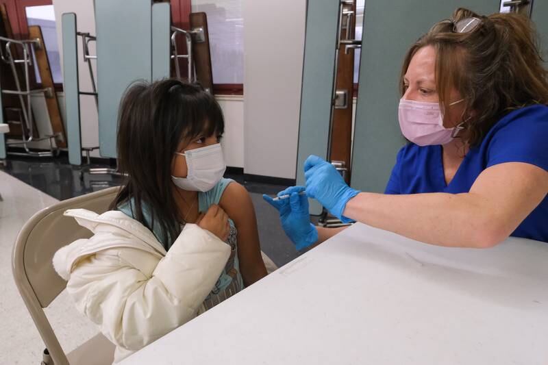 Elsa Enviquez, age 6 from Lockport, rolls up her sleeve for  her first COVID-19 vaccine shot at Fairmont Junior High School in Lockport. Wednesday, Nov.17, 2021 in Lockport.