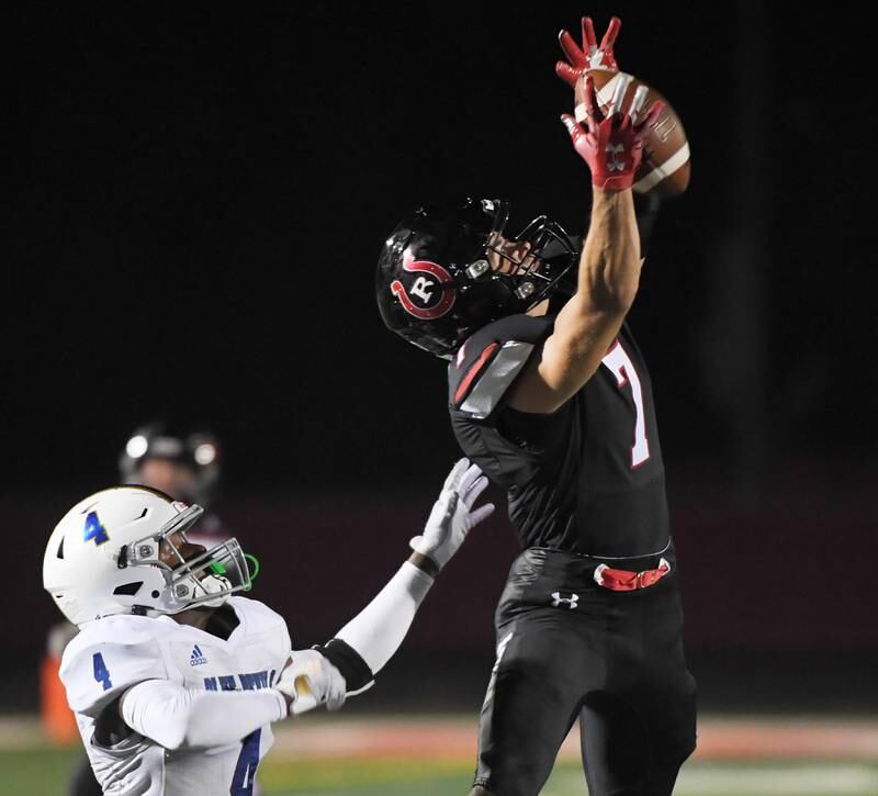 Barrington’s Matt Marusich catches a first-down pass against Warren’s XZavion Montgomery at Barrington High School Friday, August 25, 2023.