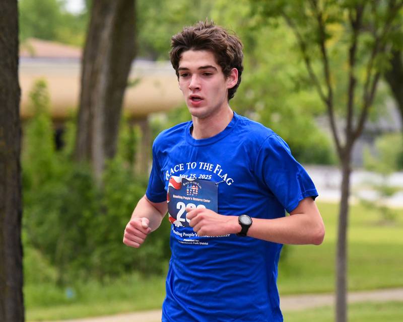 Carston Harris of Naperville runs during the Race to the Flag 5k who was the overall male winner with a time of 17:30 on Sunday May 25, 2025, held at Ty Warner Park in Westmont.