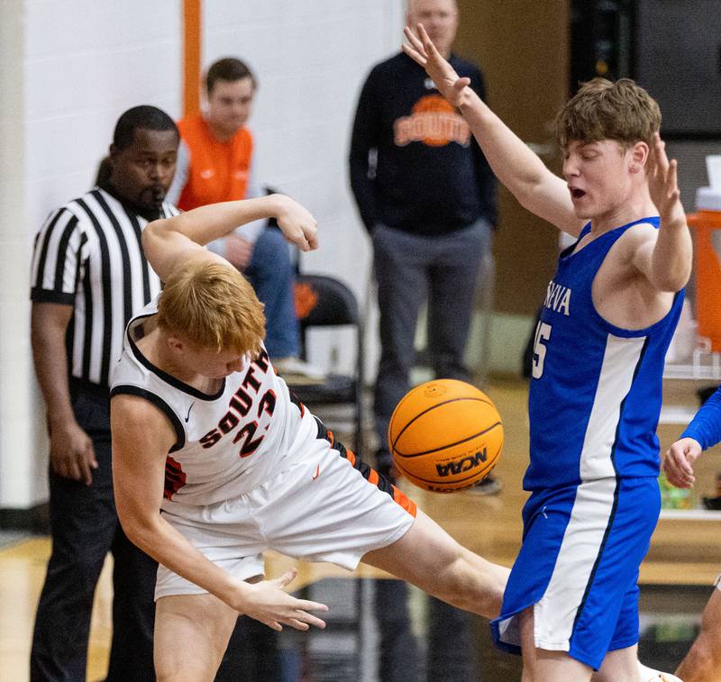 Wheaton Warrenville South’s Drew Eger throws the ball into Geneva’s Hudson Kirby in an attempt to keep possession of the ball during a game at Wheaton Warrenville South High School on Tuesday, Dec. 3, 2024.