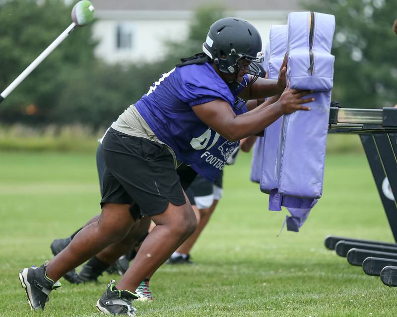 Plano's Dion Davison hits the sled at Plano High School football practice.  August 9, 2023.