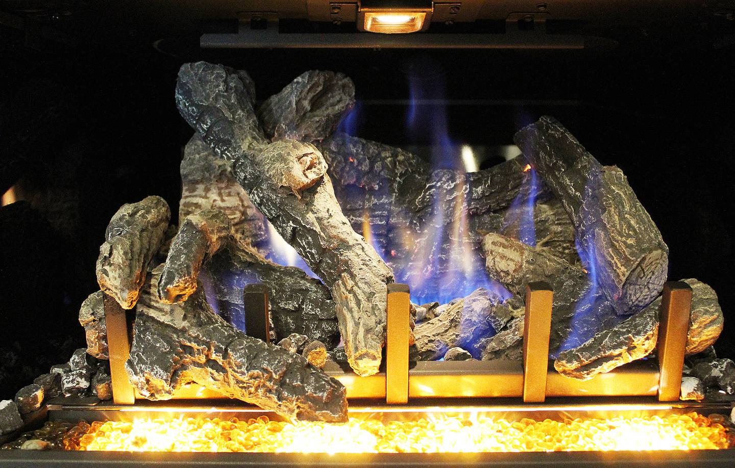 A large fireplace setup is displayed at Loescher Heating and Air Conditioning's showroom in Freeport.