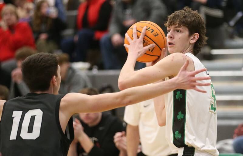 Seneca's Sebastian Deering looks to pass the ball over the head of Woodland's Jaron Follmer on Friday, Feb. 14, 2025 at Seneca High School.