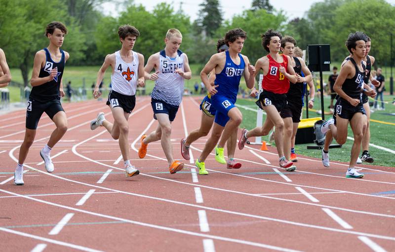 Runners begin the varsity 3200 meter race during the Dukane Conference Boys Track and Field Meet hosted by Lake Park High School in Roselle on Friday, May 16, 2025.