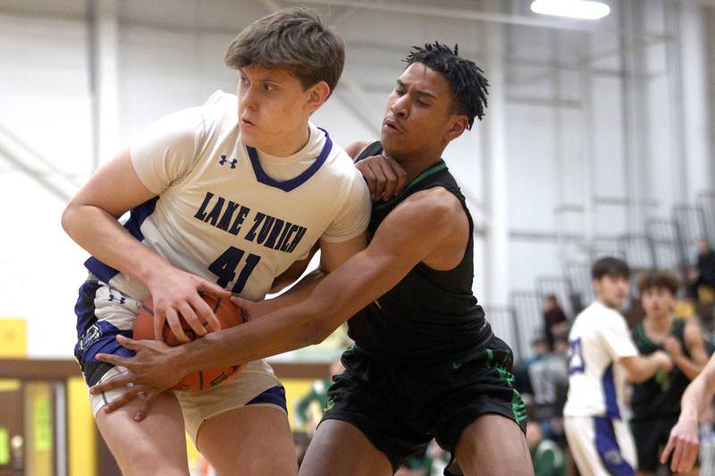 Crystal Lake South’s Christian Rohde, right, battles Lake Zurich’s Anton Strelnikov for the ball in Hinkle Holiday Classic boys basketball tournament game action at Jacobs High School Wednesday.