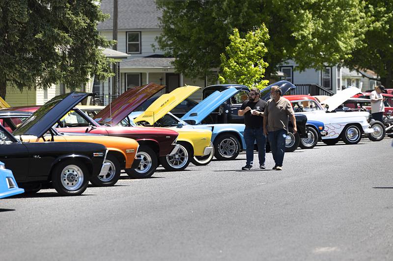Visitors tour the dozens of muscle cars and hot rods Saturday, May 11, 2024 in Franklin Grove.
