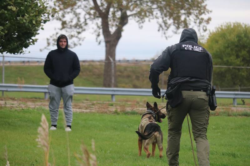DeKalb Police Department intern Ben Kuefler (left) is tracked down by DeKalb police Sgt. Steve Parsons (right) and Chase Oct. 22, 2025, upon completing a training sequence outside the former GE plant in DeKalb.
