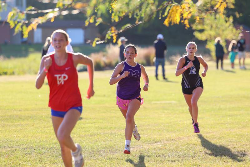 Manteno's DeLanie Monroe, center, holds on to finish in eighth place ahead of Peotone's Celeste Richards and behind Tri-Point's Khloe Miller-Dyrby in the girls 3-mile race during All-Area Cross Country meet on Wednesday, Oct. 8, 2025, at Kankakee Community College.