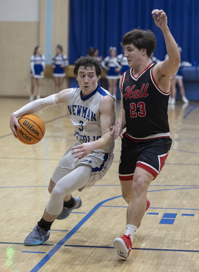 Newman’s Garret Matznick makes a behind the back pass against Hall’s Aiden Redcliff Friday, Jan. 17, 2025 at Newman High School.