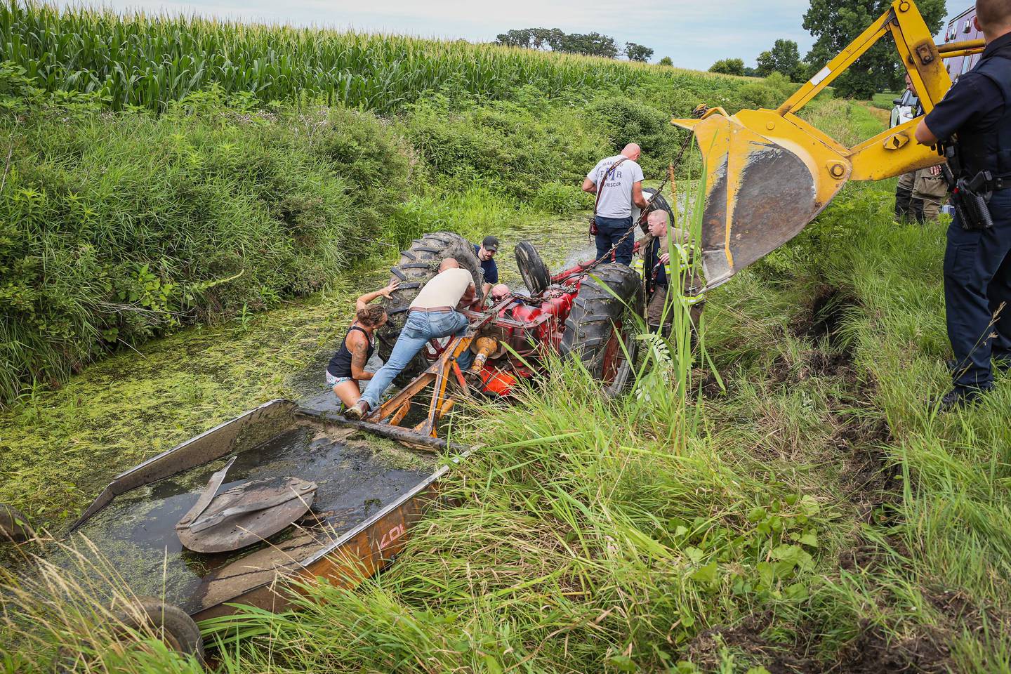 Harvard firefighters were able to free the man pinned under a tractor within 25 minutes of arriving.