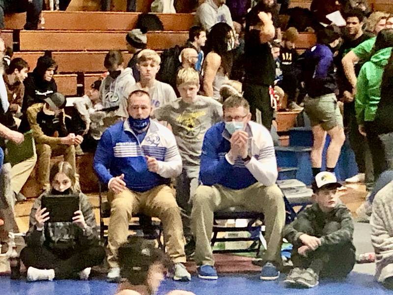 Hawk Amy takes a peak from the Tiger corner between his dad, PHS coach Steve Amy (left) and assistant R.K. Lunn during Saturday's finals of the PIT at Prouty Gym.