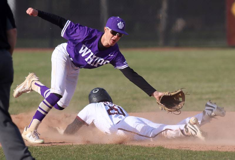 Hampshire’s Cole Harkin corrals the ball as Prairie Ridge’s Connor Innis advances safely to second base in varsity baseball on Wednesday, April 16, 2025, at Prairie Ridge High School in Crystal Lake.