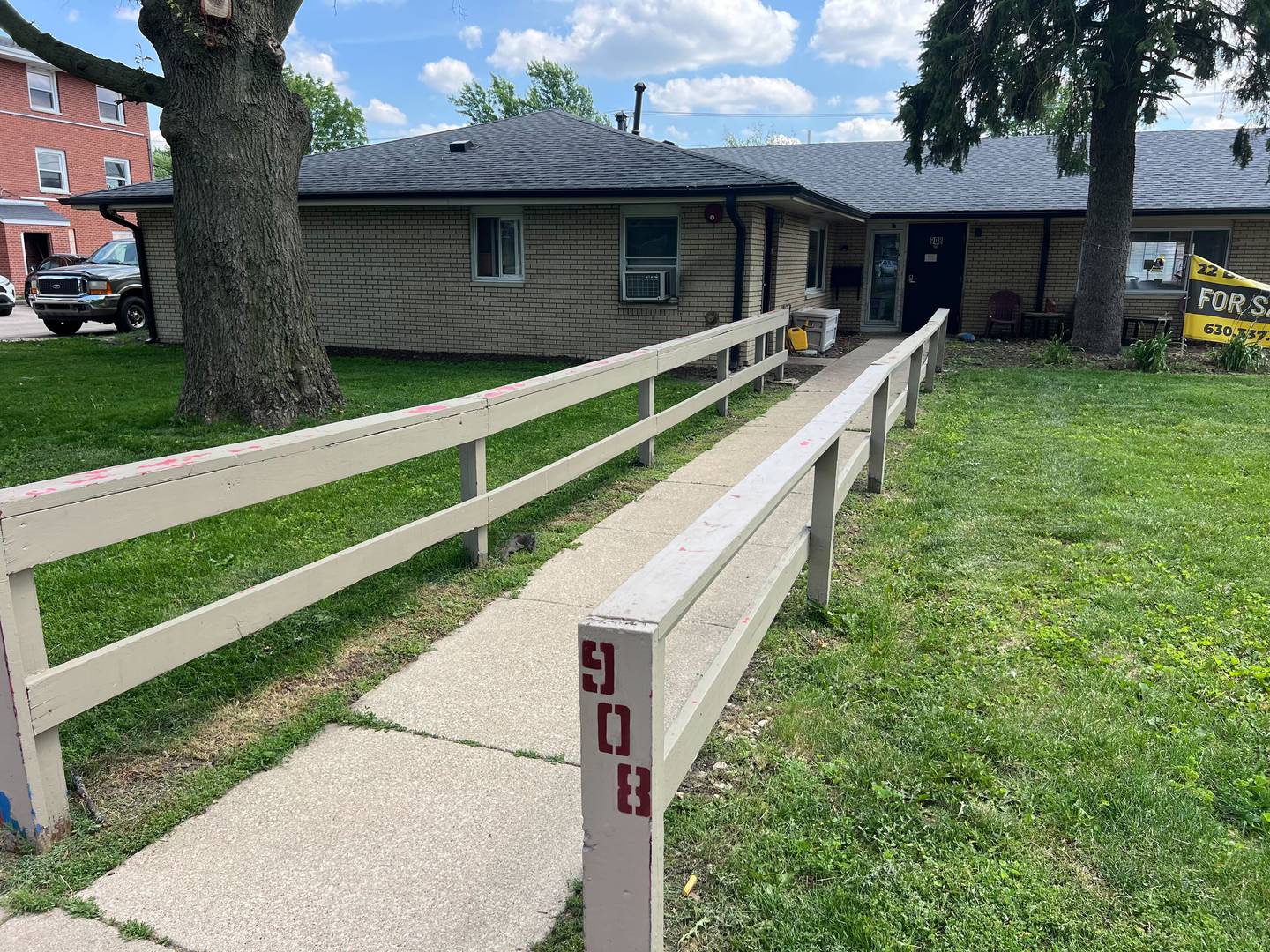 The walkway post of 908 Greenbrier Road, DeKalb, on Tuesday, June 17, 2025. A fire started in the early morning in a bathroom, leaving the building uninhabitable, injuring one person and displacing 16 residents, authorities said.
