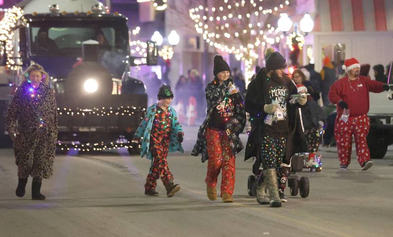 People walk during the "Night of Lights" parade on Friday, Dec. 5, 2025 downtown Princeton. The event featured the Christmas tree lighting at Veterans Park a lighted Christmas parade down Main Street,  Living Windows, a Candy Cane Hunt, and visits with Santa.