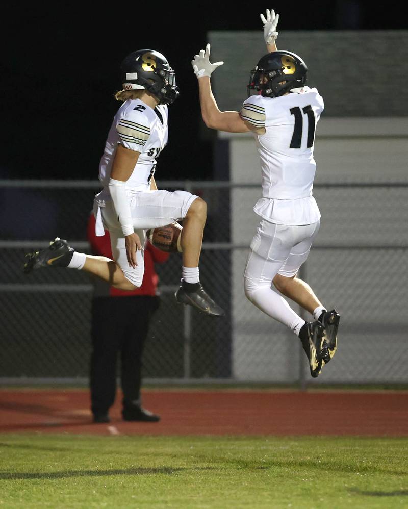 Sycamore's Elijah Meier (left) and Burke Gautcher celebrate Meier's touchdown run during their game Friday, Sept. 23, 2022, at Rochelle High School.