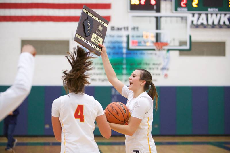 Batavia's Brooke Carlson holds up the Championship plaque after the win over Wheaton Warrenville South at the Class 4A Regional Final on Friday, Feb.26,2024 in Bartlett.