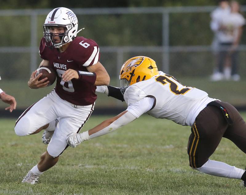 Prairie Ridge's Luke Vanderwiel tries to avoid the tackle of Jacobs' Nick Meyer during a Fox Valley Conference football game on Friday, Sept. 5, 2025, at Prairie Ridge High School in Crystal Lake.
