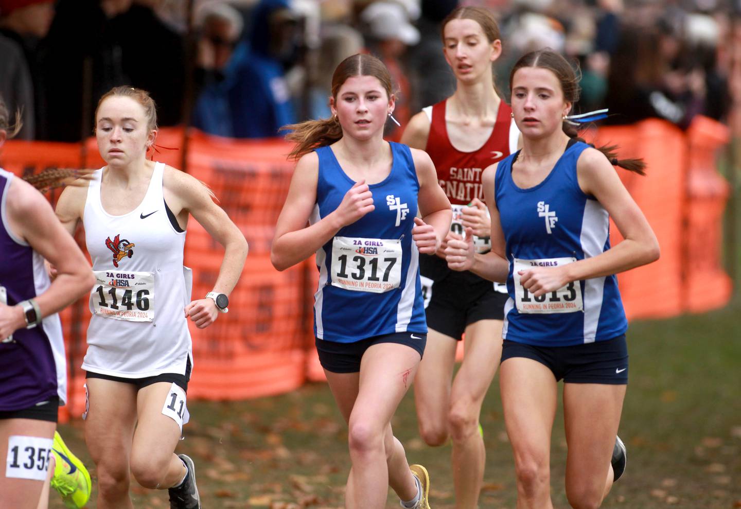 (Left to right) Benet’s Delilah Helenhouse, St. Francis’ Elena Mamminga and St. Francis’ Erin Hinsdale compete in the Class 2A State Cross Country Championships on Saturday, Nov. 9, 2024 at Detweiller Park in Peoria.