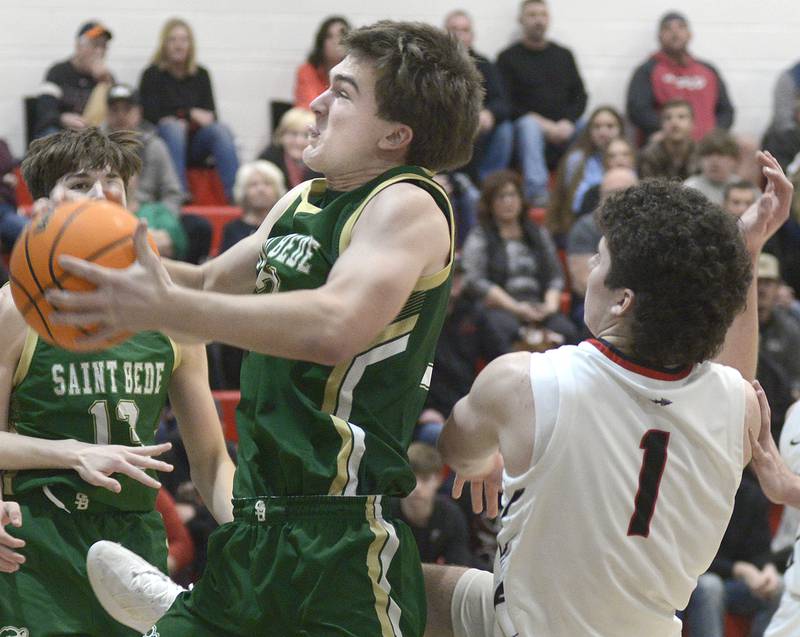 St Bede’s AJ Hermes pulls down this rebound ahead of the grab of Woodland’s Noah Decker  in the 2nd quarter Friday at Woodland.