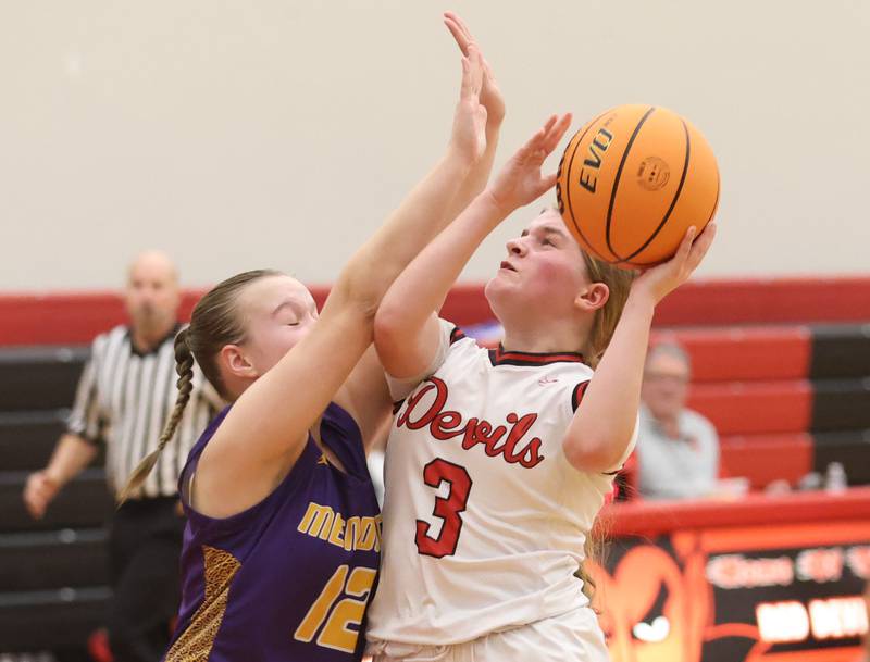 Hall's Leah Pelka eyes the hoop as Mendota's Karissa Freeman defends on Monday, Dec. 1, 2025 at Hall High School.