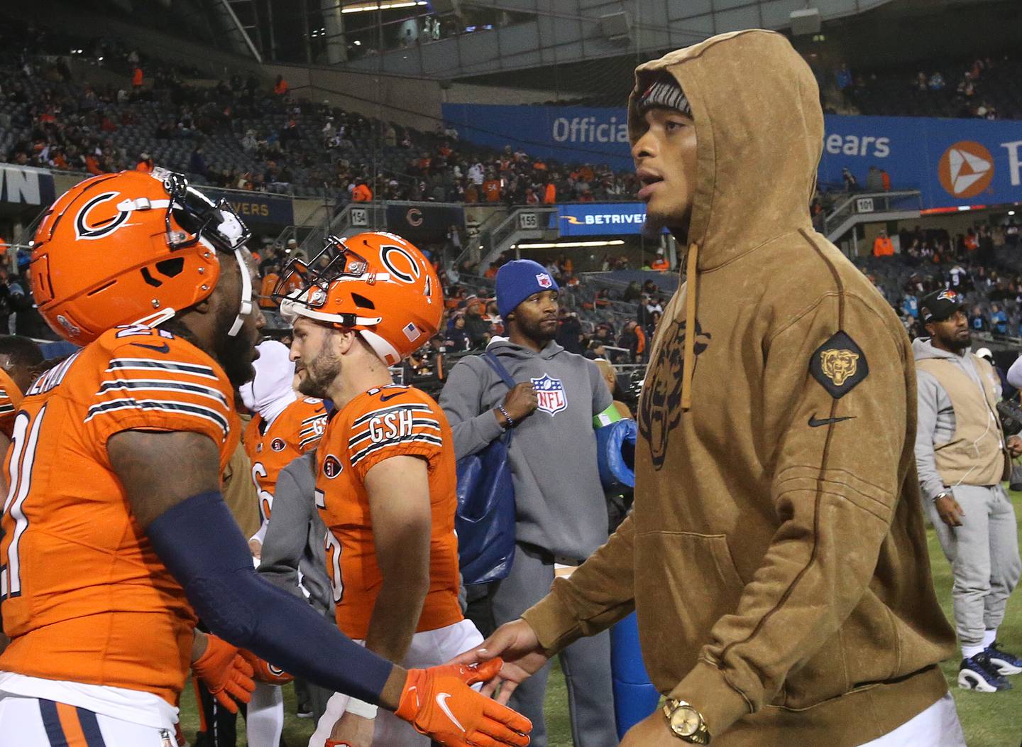 Chicago Bears quarterback Justin Fields (right) hi-fives running back D'Onta Foreman while walking off the field on Thursday, Nov. 9, 2023 at Soldier Field.