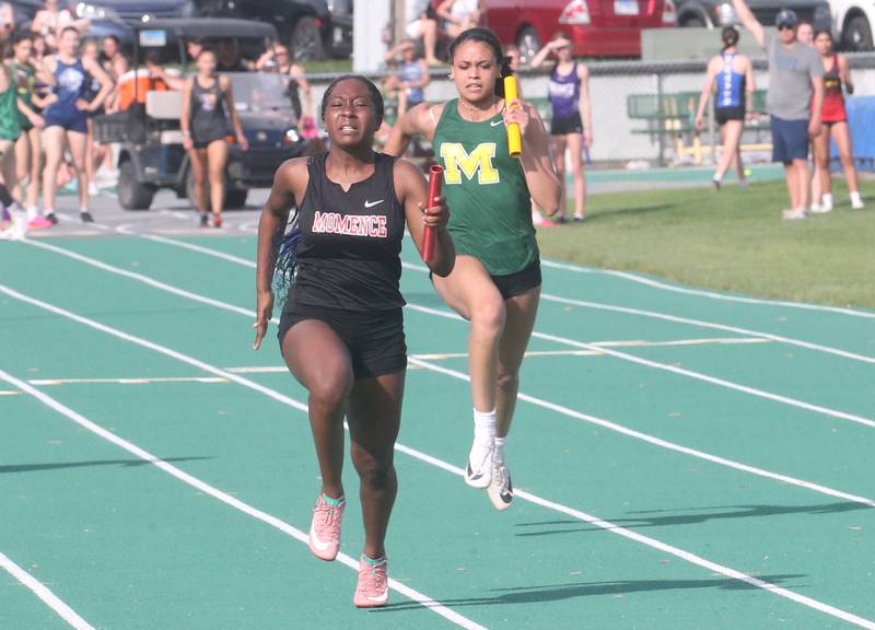 Momence's Jolie Varela sprints alongside Kankakee McNamara's Janiya Carpenter in the 4x100 meter relay during the Class 1A Sectional track meet on Thursday, May 15, 2025 at Seneca High School.