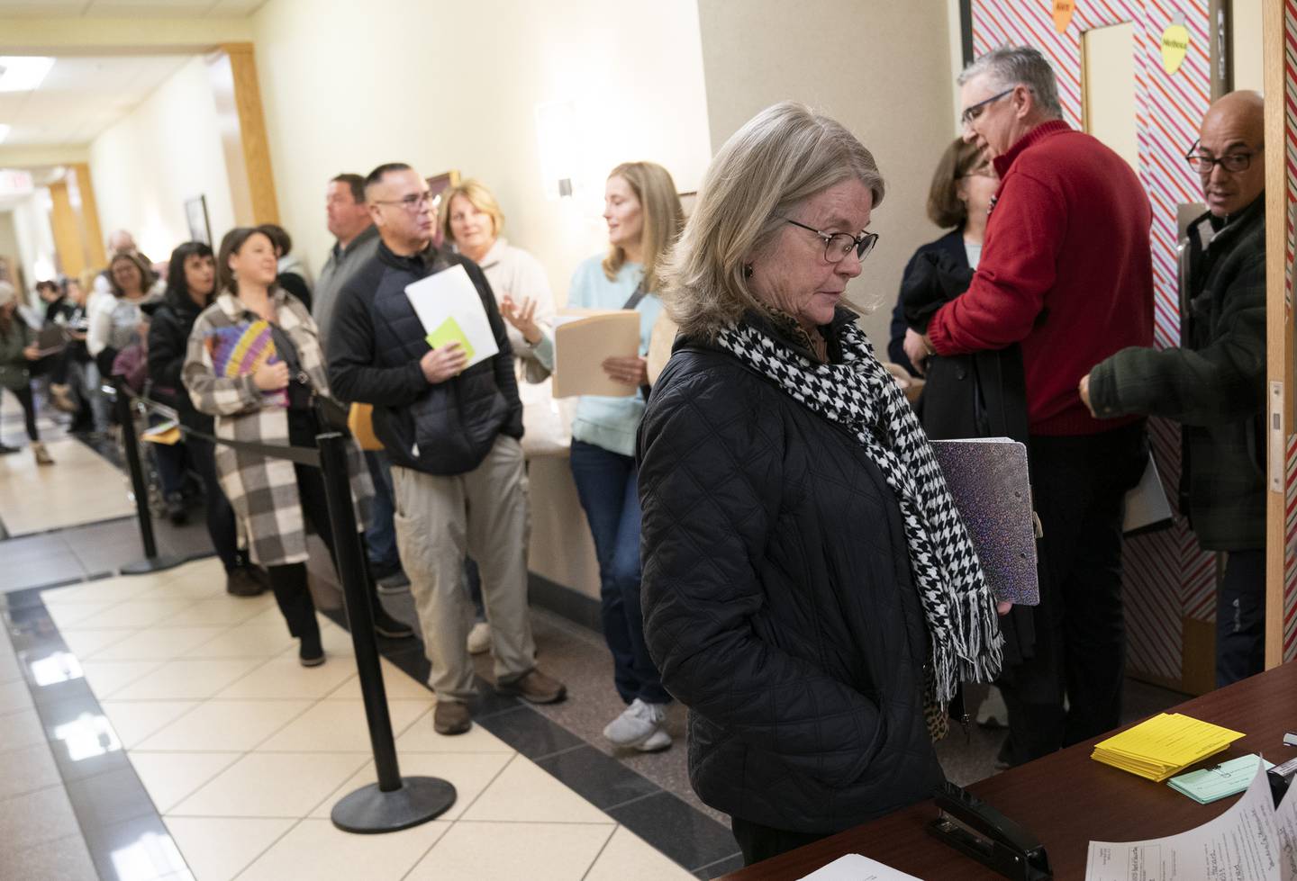 Harvard School District 50 member Sandra Theriault, right, waits in line on Monday, Dec. 12, 2022, the first day area school board candidates could file for the April election, at the McHenry County Administration Building in Woodstock.