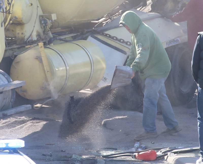 Emergency crews apply leak absorbant on Wednesday, Nov. 15, 2023, during an overturned cement truck on Route 251 near the U.S. 6 interchange in Peru.