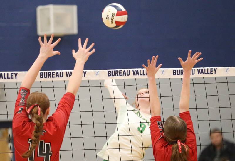 Seneca's Brooklyn Sheedy hits the ball between Erie-Prophetstown's Eden Jensen and teammte Kaylee Keegan in the Class 2A Sectional semifinal game on Tuesday, Nov. 5, 2024 at Bureau Valley High School.