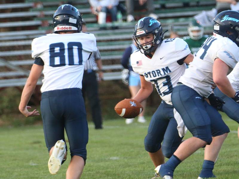 Bureau Valley quarterback Aiden Litherland hands off the ball to teammate Tyler Donnelly on Friday Aug. 29, 2025 at St. Bede Academy.