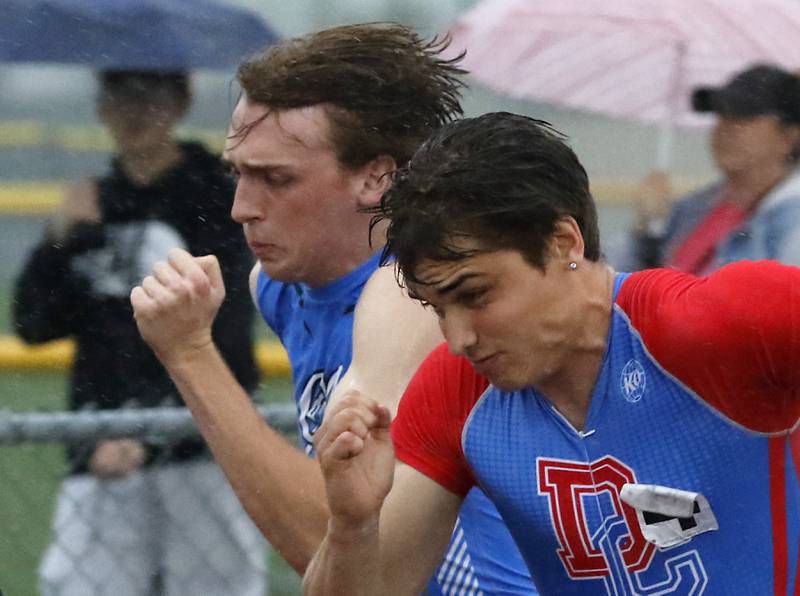 Burlington Central’s Nolan Milas and Dundee-Crown’s Henry Kennedy race neck to neck in the 100 meter dash Friday, May 12, 2023, during the Fox Valley Conference Boys Track and Field Meet at Huntley High School.