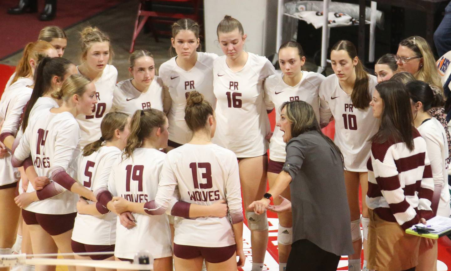 Members of the Prairie Ridge volleyball team talk with head coach Hilary Angello during the Class 3A State semifinal game on Friday, Nov. 15, 2024 at CEFCU Arena in Normal.