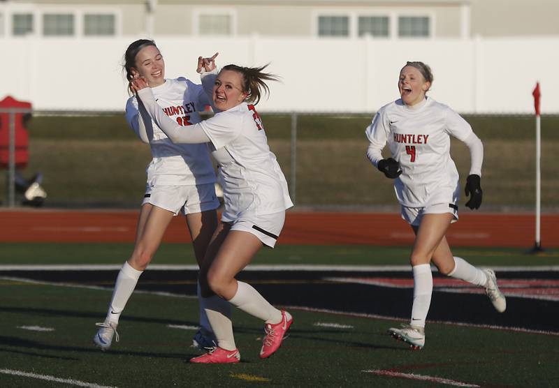 Huntley's Bella Fusco (left) celebrates her teammate, Peyton Kohn, after Kohn scored the game tying goal during a nonconference soccer game against Boylan Catholic in March 2024, at Huntley High School.