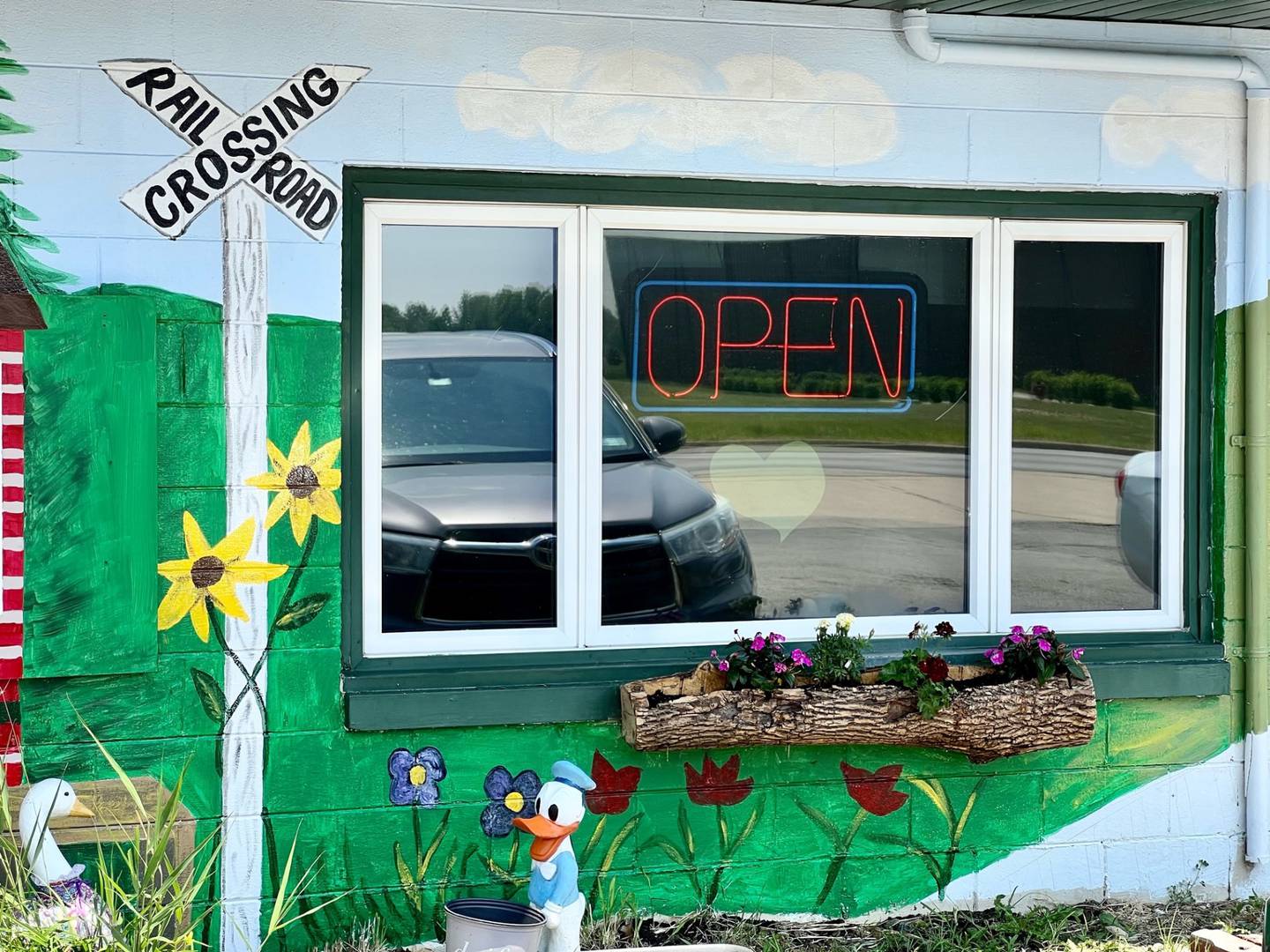 Terri Ellinger of Wilmington is painting a mural on the exterior of The Whistle Stop Cafe in Diamond, a restaurant where Ellinger frequently stops for a homemade meal.