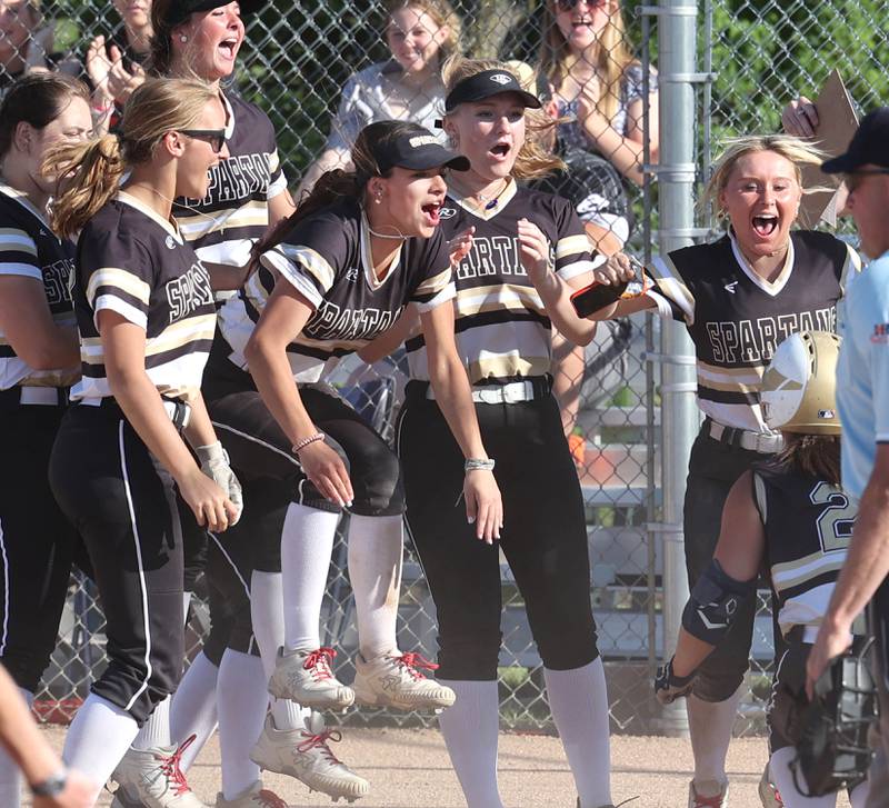 Sycamore players celebrate a home run by Kairi Lantz during their Class 3A regional championship game against Freeport Friday, May 26, 2023, at Sycamore High School.