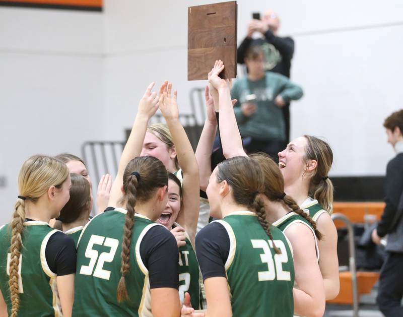 Members of the St. Bede Lady Bruin basketball team hoist  the Tri-County Conference championship trophy on Thursday, Jan. 23, 2025 at Roanoke-Benson High School.