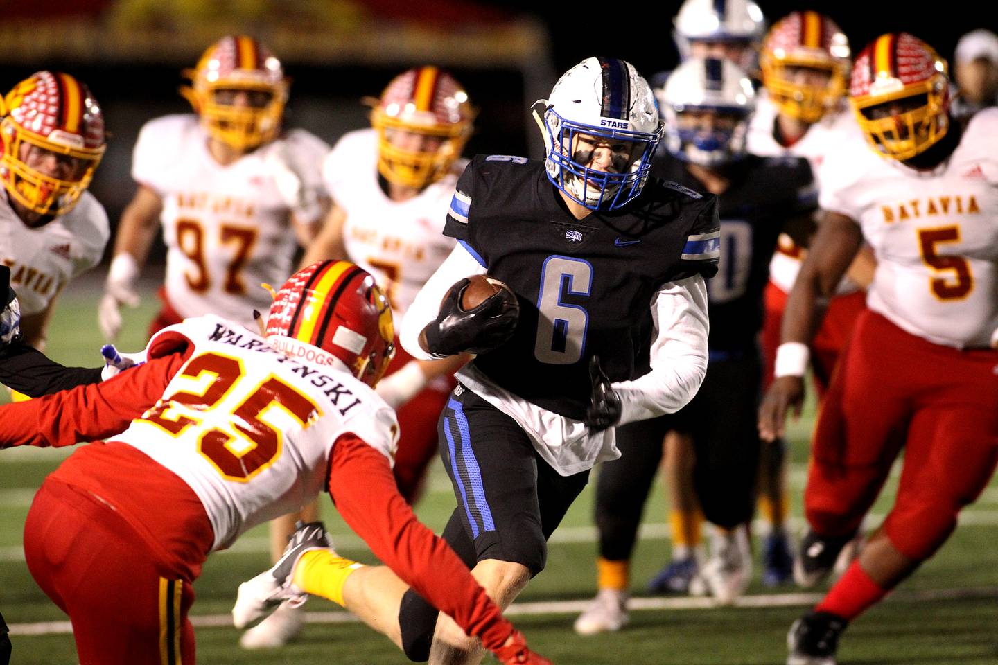 St. Charles North's Drew Surges (6) carries the ball during a game against Batavia at St. Charles North on Friday, Oct. 22, 2021.