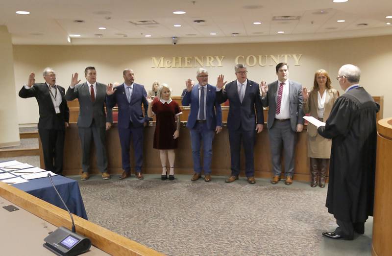 McHenry County Chief Judge Michael Feetterer administers the oath of officer to the recently elected members of the McHenry County Board on Monday, Dec. 2, 2024, at the McHenry County Administration Building in Woodstock. Sworn in from left to right: Carl Kamienski, R- Johnsburg, Mike "Shorty" Shorten, R-Crystal Lake, Paul Thomas, R-Wonder Lake, Deena Krieger, R-Island Lake, Pat Sullivan, R- Algonquin, John Collins, R-Crystal Lake, Eric Hendricks, R-Lake in the Hills and Tracie Von Bergen, R-Hebron. Also sworn in were County Board Chair Mike Buehler, R-Crystal Lake and Board member Jim Kearns, R-Huntley.