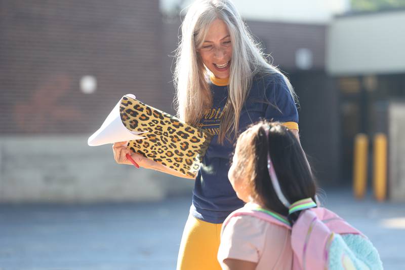 Principal Kim Gordon greets students on the first day of school at Woodland Elementary School in Joliet. Wednesday, Aug. 17, 2022, in Joliet.