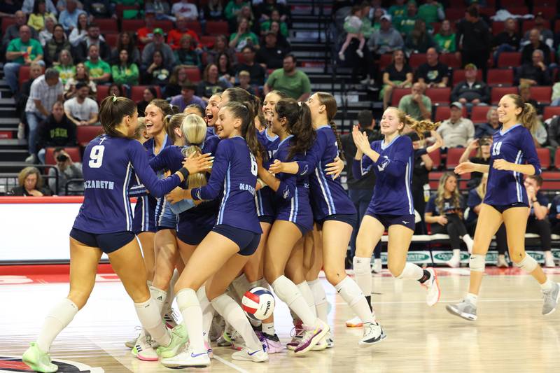 Nazareth players celebrate as the Roadrunners secured a victory in two sets, 25-16, 25-17, over Providence in the IHSA Class 3A State semifinals on Friday, Nov. 14, 2025.