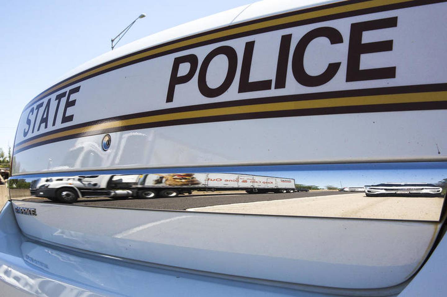 Traffic passes an Illinois State Police Car performing a traffic stop on Thursday, May 23, 2019, on I55 in Joliet, Ill. Scott's Law is named after Lieutenant Scott Gillen of the Chicago Fire Department who was struck and killed by an intoxicated driver while assisting at a crash. It requires drivers approaching police or emergency vehicles who are stopped on the roadway to reduce speeds, proceed with caution and switch lanes, if possible.