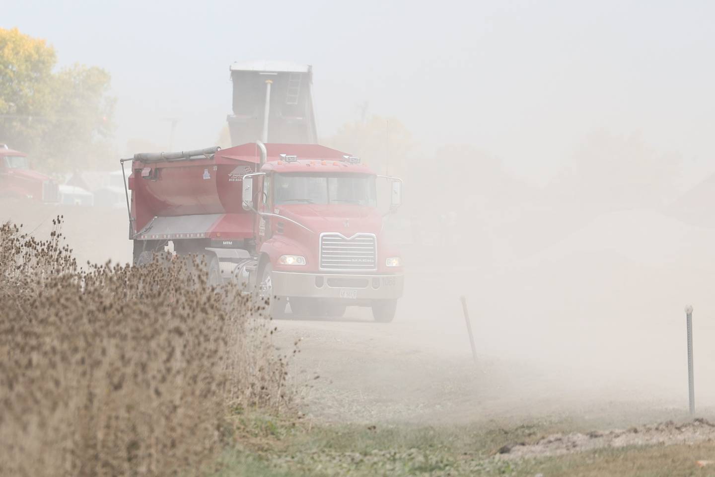 Trucks kick up dust along SE I-55 Frontage Road as groundwork continues on the Rock Run Crossings Development near the I-55 and I-80 interchange in Joliet on Tuesday, October 11th.