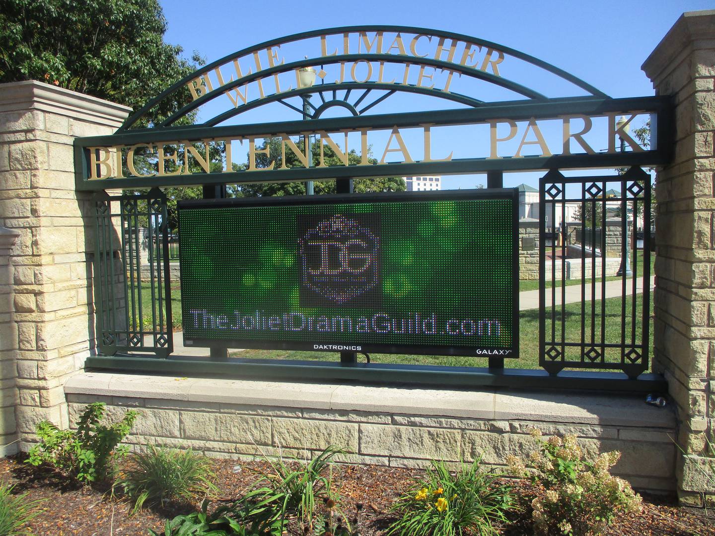 A Joliet Drama Guild graphic is shown on the electronic sign at the entrance monument for Billie Limacher Bicentennial Park in Joliet. Sept. 26, 2025