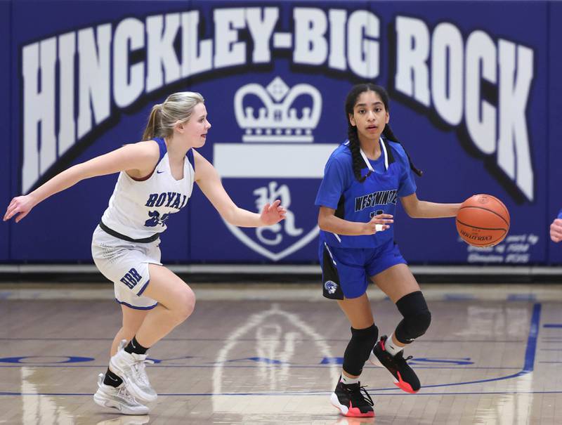 Westminster Christian's Beyah Richardson dribbles the ball up court against Hinckley-Big Rock's Anna Herrmann during their regional semifinal game Monday, Feb. 13, 2023, at Hinckley-Big Rock High School.