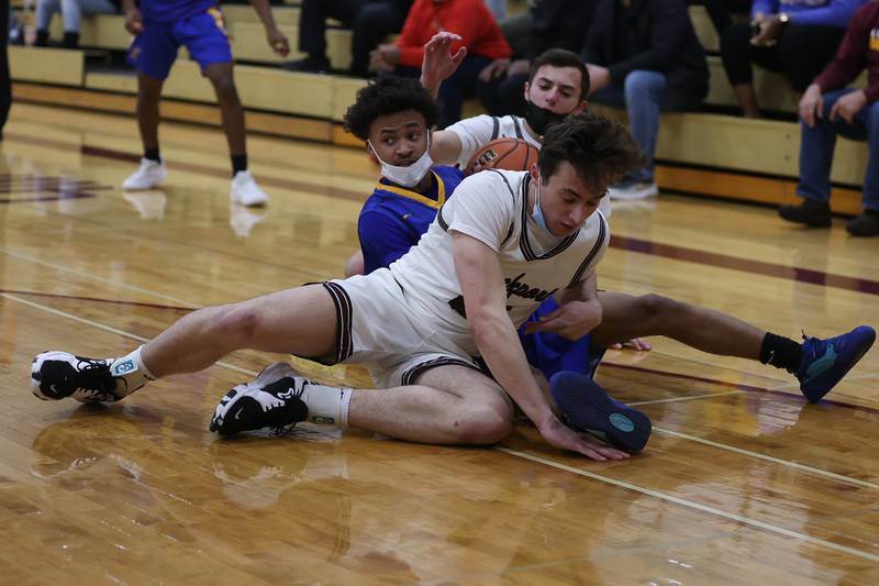 Joliet Central’s Armani Campbell forces a jump ball after the recovery against Lockport. Monday, Jan. 31, 2022 in Lockport.
