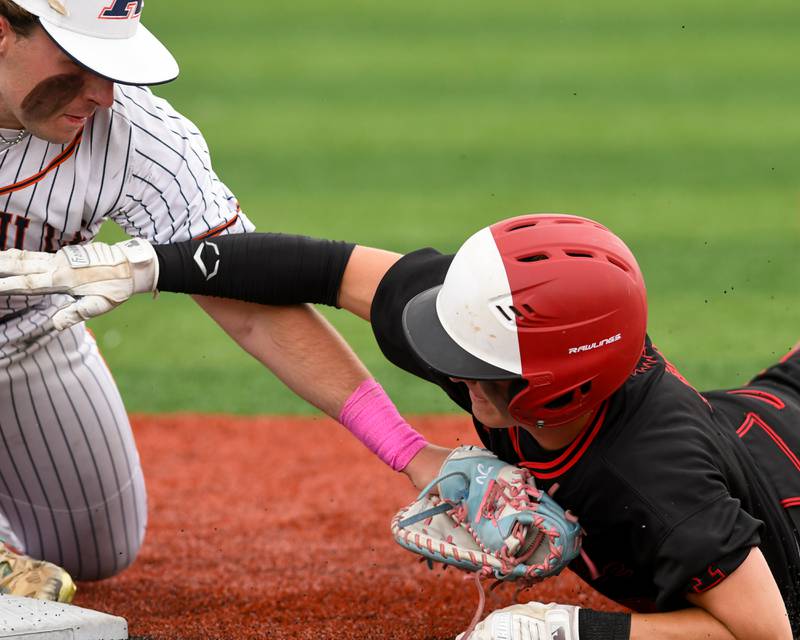 Yorkville's Justin Giese, right, gets tagged out at first by Romeoville's Nate Lubinski (14) during the regional game on Thursday May 29, 2025, held at Yorkville High School.