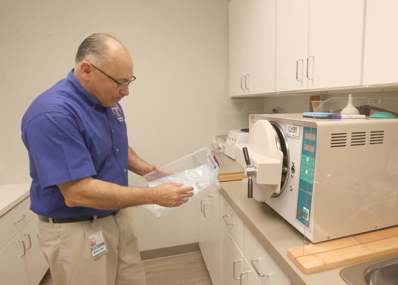 Hector Gomez, Bureau County Health Department director, sanitizes equipment at the Bureau County Family Health Clinic inside the Bureau County Health Department on Friday, June 6, 2025 in Princeton.