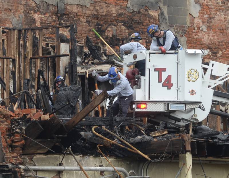 ATF investigators used a Sterling fire department ladder truck to gain access to the charred remains of an apartment building on Wednesday, July 12, 2023 as they continue to search for answers in the fatal July 7 fire at t 406 E. Third Street in Sterling.