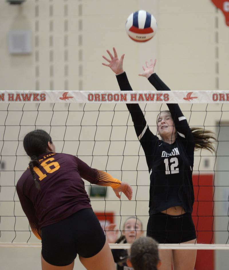 Dixon's Izzy Queckboerner (12) goes up tp block as Stockton's Ireland Mensendike (16) spikes during the championship match at the Oregon Varsity Girls Volleyball Tournament on Saturday, Sept. 6, 2025 at the Blackhawk Center in Oregon. Dixon fell in two matches.